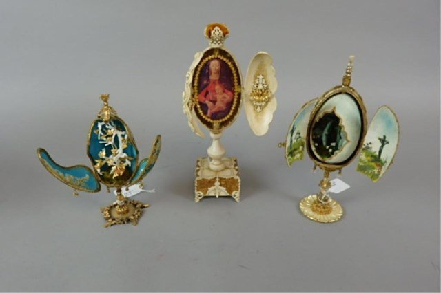 Three Elaborate Eggs: 7.25" - 10" with hinged doors which open, revealing religious and decorative interiors, made by Glenroy Dankel, unique and one of a kind.