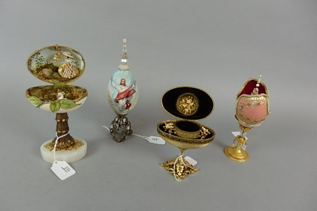Four Elaborate Eggs: Four elaborate eggs, ranging from 4.5" - 8," three of them are hinged to reveal jewelry box and interior figures, one is handpainted and bead decorated, religious, made by Glenroy Dankel, unique and o