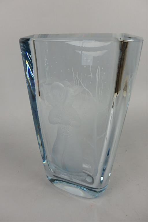 Strombergshyttan Pale Blue Etched Vase: 10.5" with a 6.75" opening, signed Strombergshyttan, numbered BY064-C1360 Sweden, pale blue etched vase, etched with a woman in long coat with fur collar and muff, snowflakes falling, winter scene.