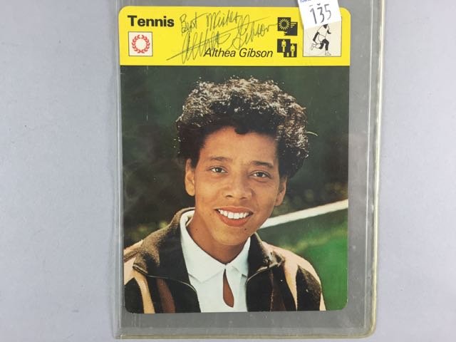 Althea Gibson Autograph: Althea Gibson Autograph on a tennis sports card with her image, 6.25" t x 4.75" w, ink signed on yellow upper center, comes with a Certificate of Authenticity. Condition - Mint