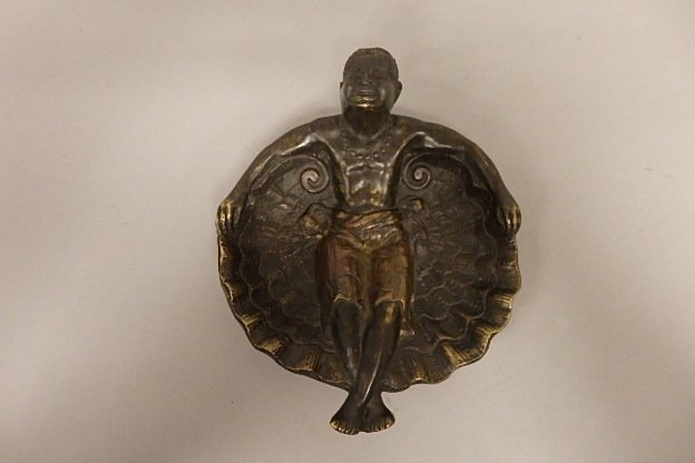 Bronze African-American Desk Piece: Bronze African-American Desk Piece 6.5" x 5.25" bronze dish depicting an African-American man reclining on large shell, bare chested, wearing a necklace.