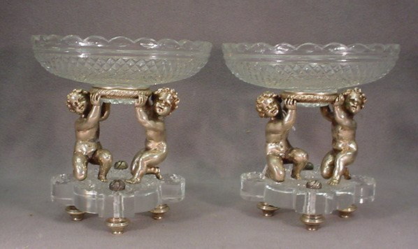 Baccarat pair of 20th Century centerpieces: Baccarat pair of 20th Century silver plated bronze & crystal centerpieces, marked. 8 1/4"H x 7 3/4"W. Shipping in USA is $ 50.00. International bidders ask before bid.