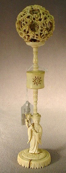 Chinese carved ivory puzzle ball: Chinese carved ivory puzzle ball on a column with a woman on base. 11"H. Shipping in USA is $ 30.00. International bidders ask before bid.