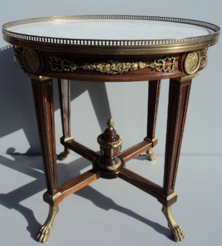 French empire table in the manner of F. Linke: French empire mahogany table in the manner of F. Linke, with bronze details and marble top. 30 1/4'' H x 29 1/4'' W x 25 1/4" D. Shipping in USA is $ 150.00. International bidders ask before bid.