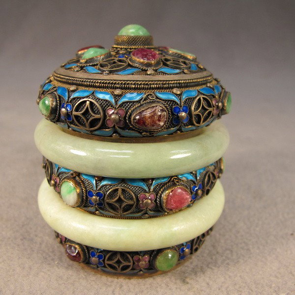 Chinese silver enamel round box: Chinese silver filigree enamel, jade and precious stones round lidded box, marked. 3 1/2" H x 3" W. Shipping in USA is $ 25.00. International bidders ask before bid.
