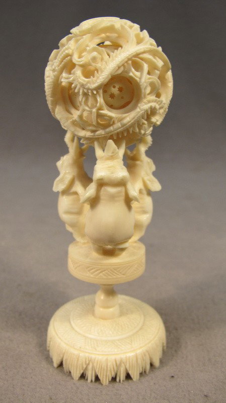 Chinese carved ivory puzzle ball: Chinese carved ivory puzzle ball on a elephants base. 5 1/4" H x 1 7/8" W. Shipping in USA is $ 30.00. International bidders ask before bid.