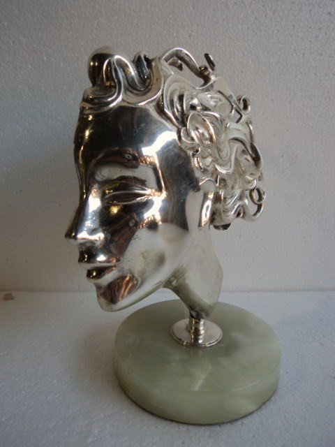 Art deco bronze bronze sculpture: Art deco bronze head sculpture on an onyx base. 10'' H x 9 1/2'' W x 5" D. Shipping in USA is $ 30.00.