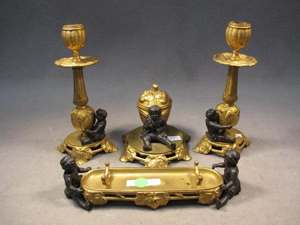 French bronze of 4 pcs desk set: French gilt bronze of 4 pcs desk set. Candelabra: 8 1/2" H, pen stand: 9 1/4" long. Shipping in USA is $ 40.00. International bidders ask before bid