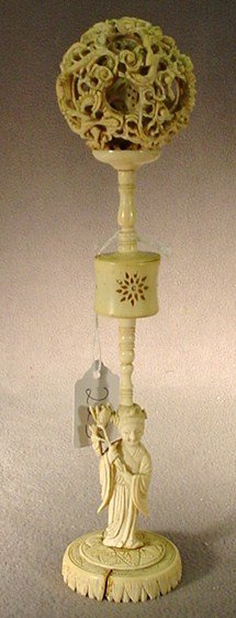 Chinese carved ivory puzzle ball: Chinese carved ivory puzzle ball on a column with a woman on base. 11"H. Shipping in USA is $ 30.00. International bidders ask before bid.