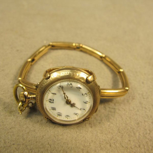 Ols lady 10 kt gold pocket/bracelet watch: Ols lady 10 kt gold pocket/bracelet watch, guilloche and enamel, marked. 2" diameter. Shipping in USA is $ 20.00. International bidders ask before bid