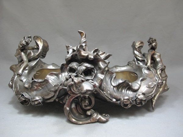 Anton K. NELSON (1880-1910) centerpiece: Anton K. NELSON (1880-1910) empty bronze silver-plated centerpiece, signed. 9 1/2" H x 23" W. Shipping in USA is $ 65.00. International bidders ask before bid.