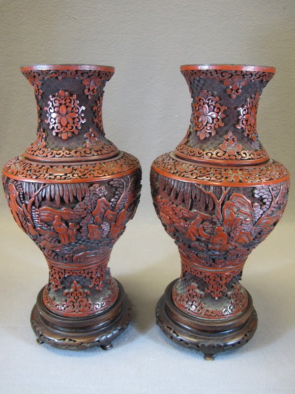 Chinese pair of cinnabar vases: Chinese pair of cinnabar vases with a wood base. 15 3/4" H. Shipping in USA is $ 70.00. International bidders ask for shipping before bid.