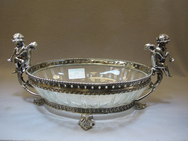 20th C marked Baccarat centerpiece: 20th C marked Baccarat glass & silverplate on bronze centerpiece. 11 1/2” H x 26” W x 14 1/8” D. Shipping in USA is $ 80.00. International bidders ask for shipping before bid.