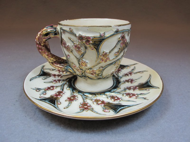 Old Hungary Zsolnay porcelain cup: Old Hungary Zsolnay porcelain cup and plate, marked. 3” H x 5 1/2” W. Shipping in USA is $ 25.00. International bidders ask for shipping before bid.