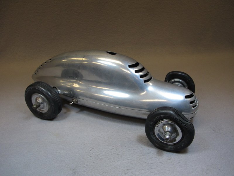 antique Art Deco aluminum tether car: antique Art Deco aluminum tether car. 6 1/4" H x 18 1/2” W x 9” D. Shipping in USA is $ 45.00. USA or International bidders ask for shipping before bid.