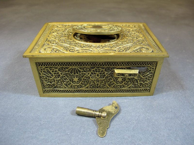 Antique Swiss bronze bird music box: Antique Swiss bronze bird music box with the original key. 1 3/4” H x 4 1/8” W x 2 3/4” D. Shipping in USA is $ 20.00. International bidders ask for shipping before bid.