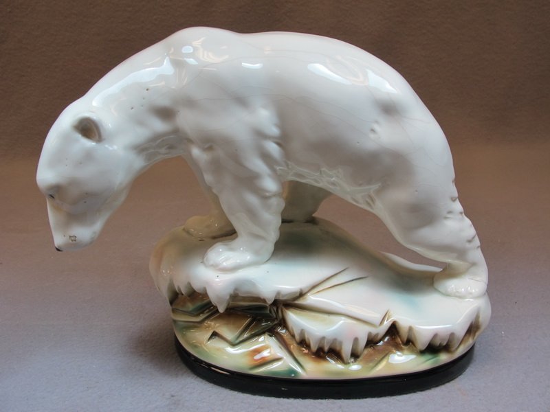 Old polar bear ceramic or porcelain statue: Old polar bear ceramic or porcelain statue. 8 1/2" H x 10 1/2” W. Shipping in USA is $ 45.00. International bidders ask for shipping before bid.