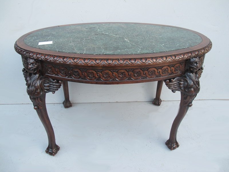 Antique English carved mahogany oval table: Antique English carved mahogany oval table with a marble top. 30 1/2" H x 50 1/2” W x 31 1/2” D. Shipping in USA is $ 280.00. USA or International bidders ask for shipping before bid.