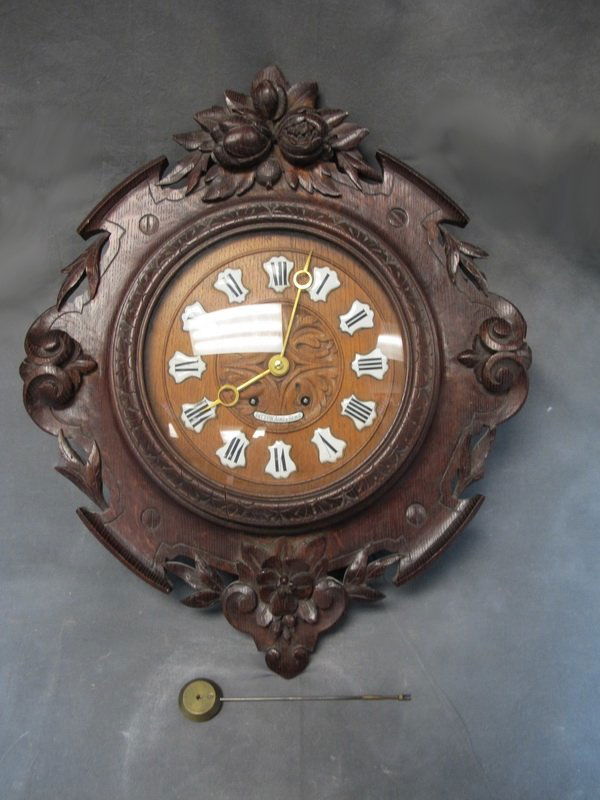 Old carved wood wall clock: Old carved wood wall clock. 23â€ H x 18 3/4â€ W. Shipping in USA is $ 65.00. International bidders ask for shipping before bid.