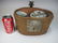 Antique Chinese teapot in a rattan basket