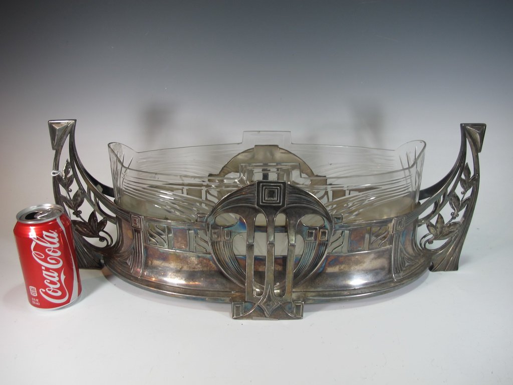 German WMF Art Deco centerpiece: German WMF Art Deco metal & glass centerpiece, marked. 8 1/2" H x 23" W. Shipping in USA is $ 65.00. International bidder ask for shipping before bid.