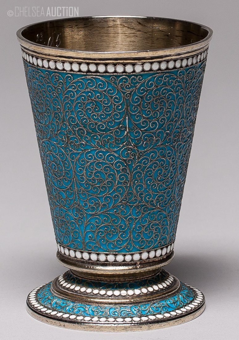 19th C Russian Blue Enamel Silver Cup: 1892 Russian blue enameled gilded silver cup. Hallmarked Moscow, Imperial warrant and 84 standard (875/1000 silver), maker mark Cyrillic “L. O.” Monogramed on the inside. SIZE: L 3 1/4 in and W 2 