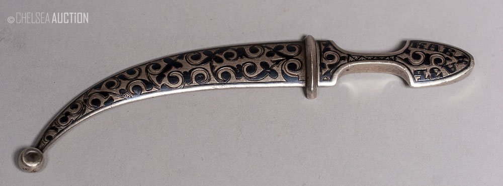 19th C. Caucasian Curved Dagger: 19th century small Caucasian dagger with silver and niello mounts. Nice curved pointy blade with the word Caucasus in Russian on the grip. SIZE: L 5 1/2 in and W 3/4 in (14 cm x 2 cm)