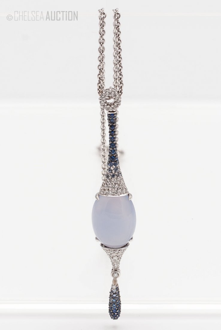 Pendant w/ Diamonds, Moonstone & Sapphires: 18k White gold pendant w/ diamonds, moonstone and sapphires. SIZE: Pendant L 2 1/4 in (6.5 cm) WEIGHT: 11.8 g.