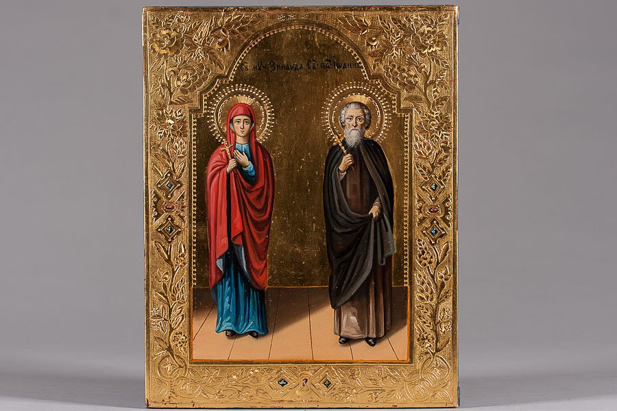 19th C. Russian Icon: St. Zinaida & St. John: 19th Century icon, Moscow. Egg tempera, gold leaf and gesso on wood panel. Borders of the icon are decorated with punched ground decoration and multi colored, simulated enamel. Two insert splits on to