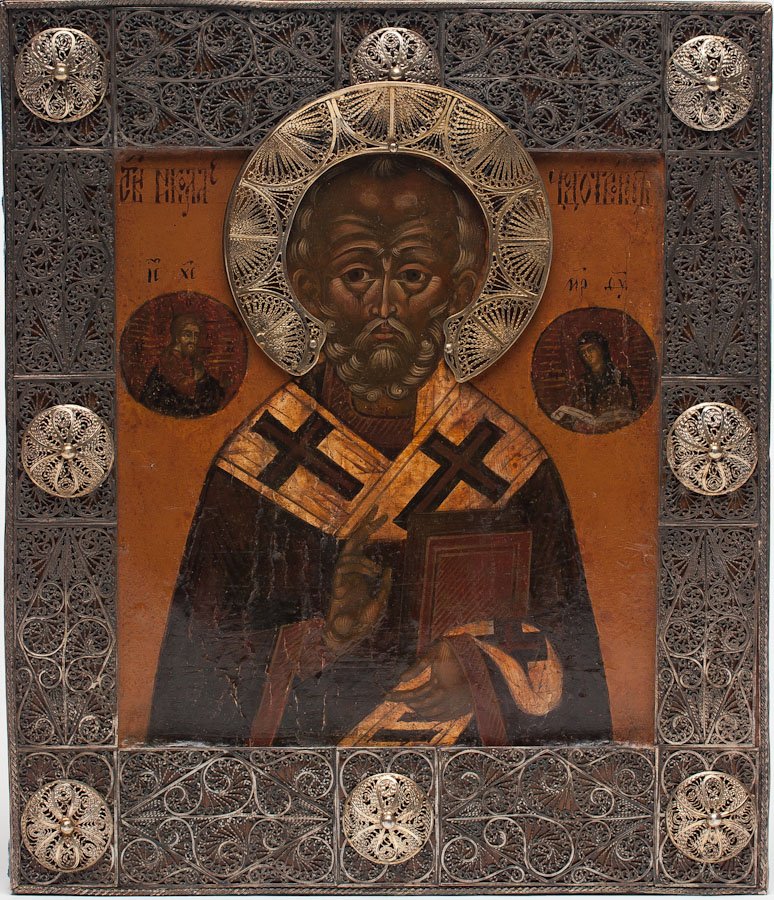 A RUSSIAN ICON OF ST. NICHOLAS, 19TH C.: A Russian icon of St. Nicholas, Moscow Workshop, 19th century. Overlaid with silver-gilt filigree cover (Basma). Hallmarked 84 standard (875/1000 silver). Egg tempera, gold leaf and gesso on wood pane