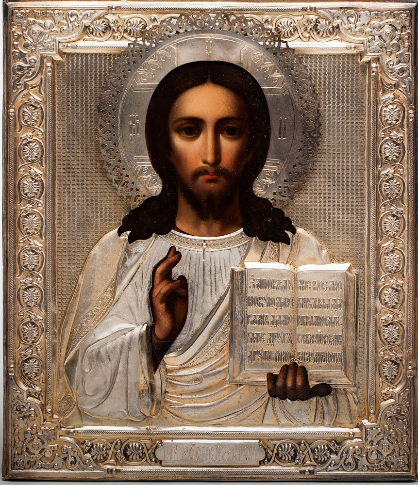 A RUSSIAN ICON OF CHRIST PANTOCRATOR, 19TH C.: A Russian icon of Christ Pantocrator, Moscow Workshop, 19th century. Overlaid with silver-gilt repose and chased cover (oklad). Hallmarked Moscow, Imperial warrant and 84 standard (875/1000 silver), m