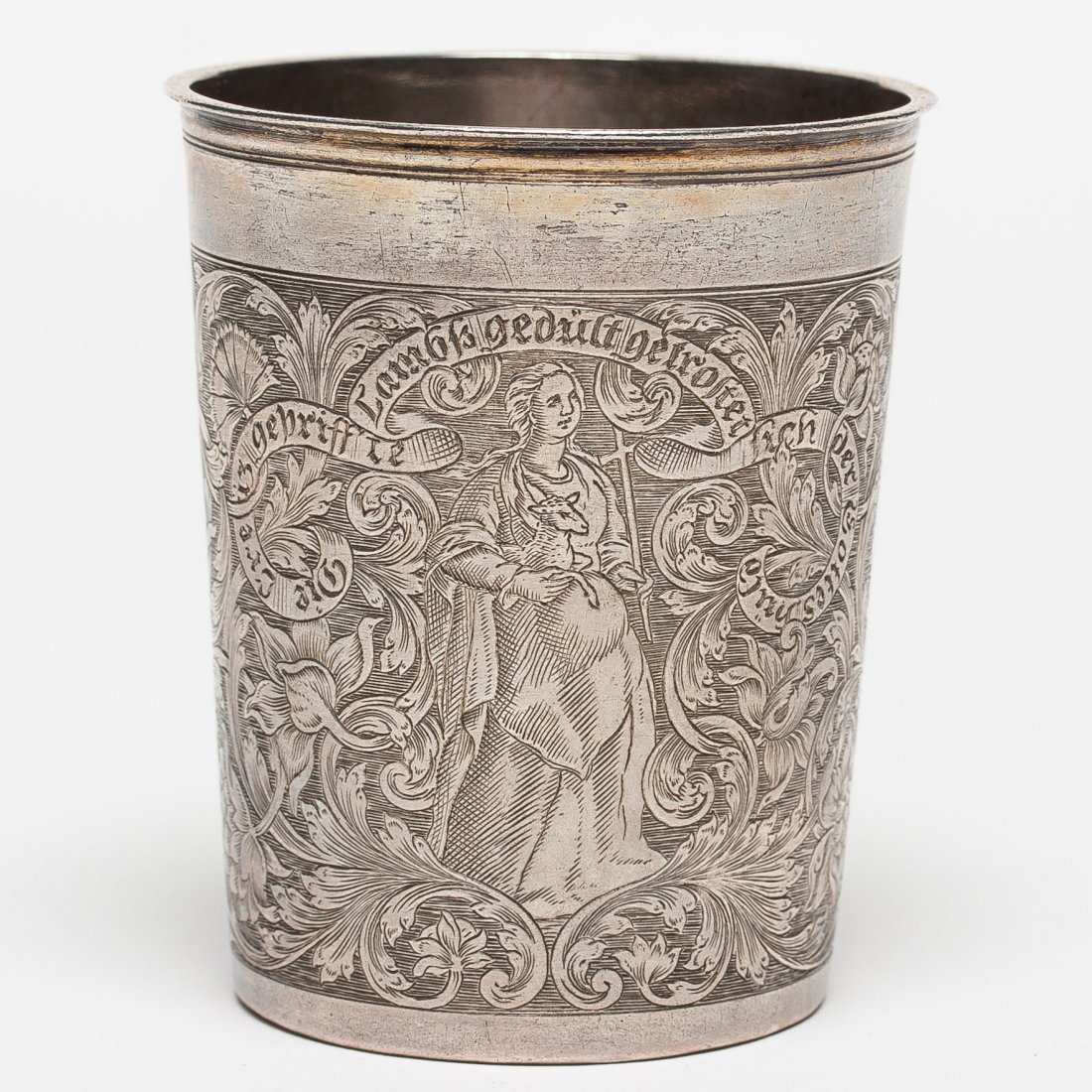 A German Silver Beaker, 1731-33: A German silver beaker, 1731-33. Hallmarked Augsburg, maker mark indistinct. The body of the beaker is engraved with scrolling foliage against matted ground one side with Hope and the other side with 