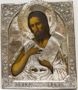 A RUSSIAN ICON OF JOHN THE THEOLOGIAN: A Russian icon of John the Theologian, 19th century, Moscow. Oil, egg tempera and gesso on wood. Silver oklad hallmarked St. Petersburg, Imperial warrant and 84 standard, 1886, makerâ€™s mark