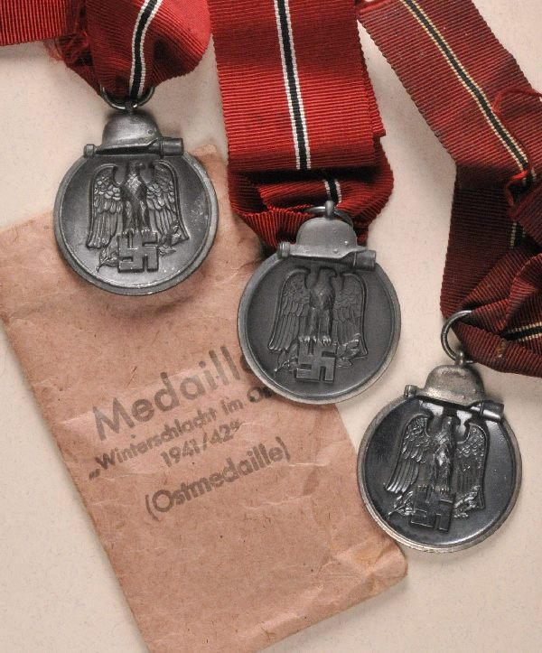 Germany (1933-1945) - Lot of 3 Eastern Fron Medals: Germany (1933-1945) - Lot of 3 Eastern Fron Medals. Zinc partially silvered hallmarked: 6. and 65 all on ribbon with award badge with makers tag Fritz Zimmermann Stuttgart. Deutsches Reich (1933-1945)