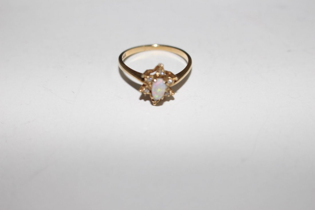 14 K OPAL STARBURST RING FEATURES SOLITAIRE OVAL OPAL: 14 K OPAL STARBURST RING FEATURES SOLITAIRE OVAL OPAL WITH 6 DIAMONDS IN A STARBURST PATTERN SIZE 7