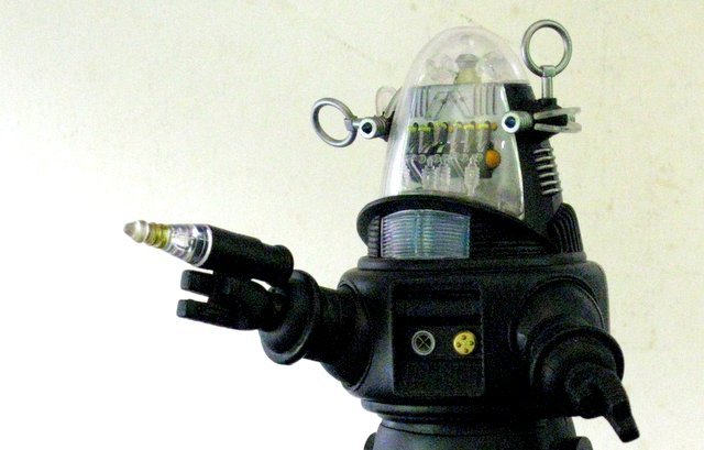 ROBBY THE ROBOT DELUXE ACTION FIGURE - Medi Com Toy,: ROBBY THE ROBOT DELUXE ACTION FIGURE - Medi Com Toy, 2000. 8 1/2" tall fully poseable figure of Robby the Robot from Forbidden Planet. Features light up function and removable blaster pistol. Near Min