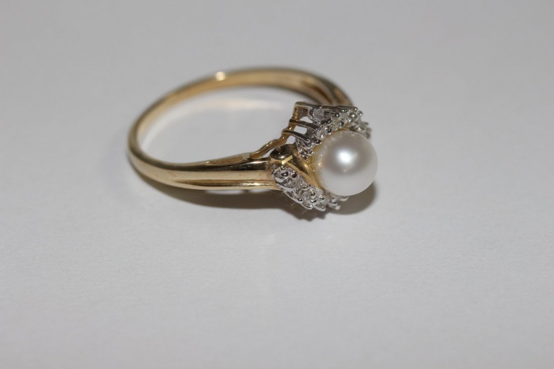 PEARL AND DIAMOND RING FEATURES SOLITAIRE CENTER PEARL (1 of 4)