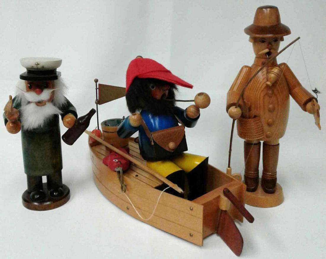 Collection of Three Wooden Smokers to Include One Sea: Collection of Three Wooden Smokers to Include One Sea Caption Smoker 7", One Reuge Fisherman in Boat 7" (Doesn't Play Music), and One Echt Erzgebirgische Handarbeit Fisherman 9 1/2". Made In Germany.