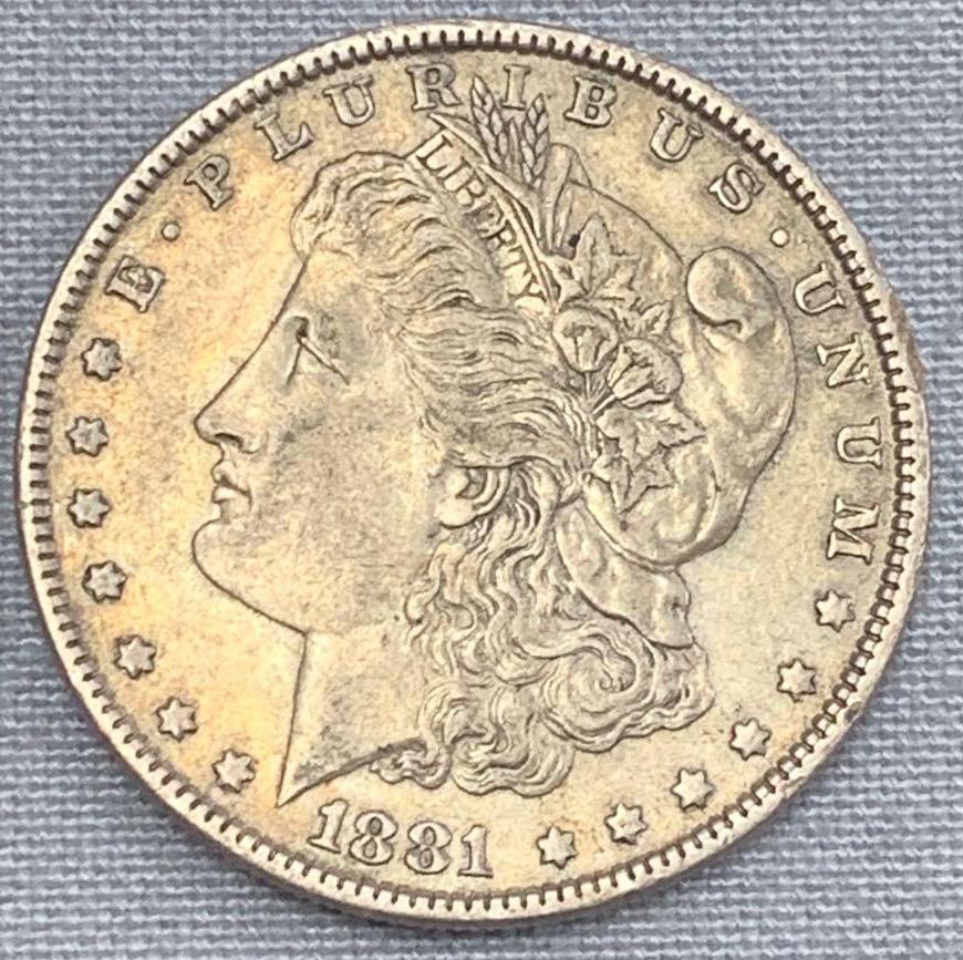 One 1881 Morgan Silver Dollar: One 1881 Morgan Silver Dollar, Philadelphia Mint, Approximately Very Good Condition. The Morgan Silver Dollar was first introduced in 1878, but it was by no means the first of its type. Silver Do