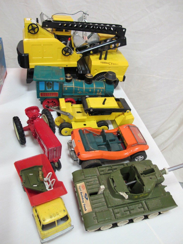 6 Metal & Plastic Toy Trucks Including: Mighty Tonk: 6 Metal & Plastic Toy Trucks Including: Mighty Tonka Crane, Western Train, Tonka Loader, Running Bouncing Battery Operated Dune Buggy, Remco Light Bulldog Tank, Dump Truck and International Tractor