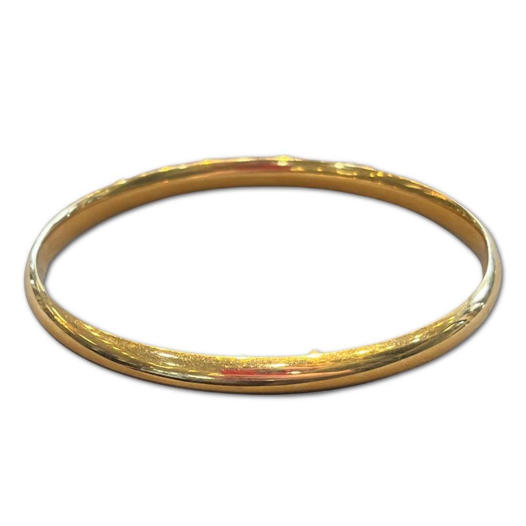 14k Yellow Gold Minimalist Hollow Bangle: 14k Yellow Gold Minimalist Hollow Bangle. The bracelet weighs approximately 4.01dwt.