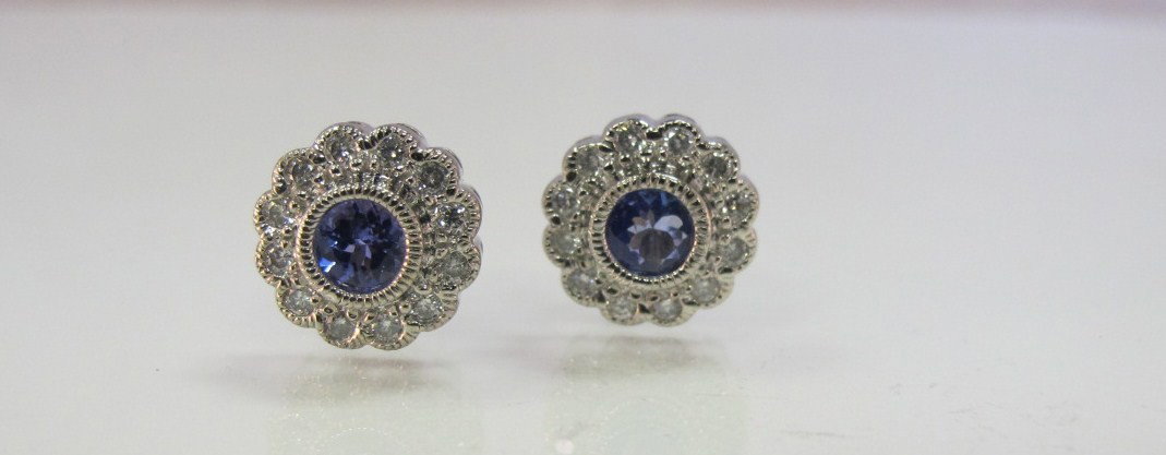 14K White Gold Tanzanite & Diamond Earrings Contain: 14K White Gold Tanzanite & Diamond Earrings Containing 2 Brilliant Cut Tanzanites=1ct. And 24 Brilliant Cut Diamonds=.72cts.