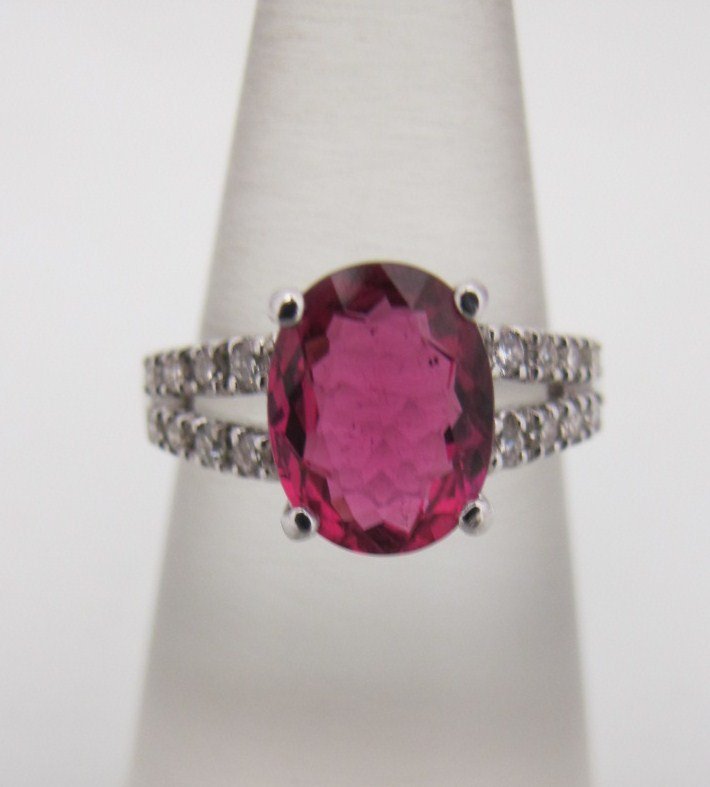 18K White Gold Rubelite & Diamond Ring Containing O: 18K White Gold Rubelite & Diamond Ring Containing One Genuine Oval Cut Rubelite = 2.07cts., and 16 Brilliant Cut Diamonds=.27cts.