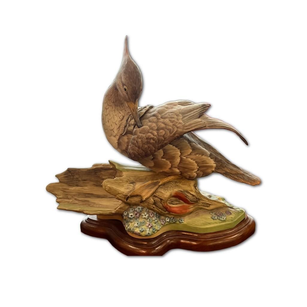 Rare Boehm Porcelain Hooded Merganser Female Bird: Rare Boehm Porcelain Hooded Merganser Female Bird. This Bird Is From 1968. This Bird Is 11 Inches In Height. This Item Depicts Bird Cleaning Wing On Top Of A Log. Item Also Depicts Blue and Purple Flo