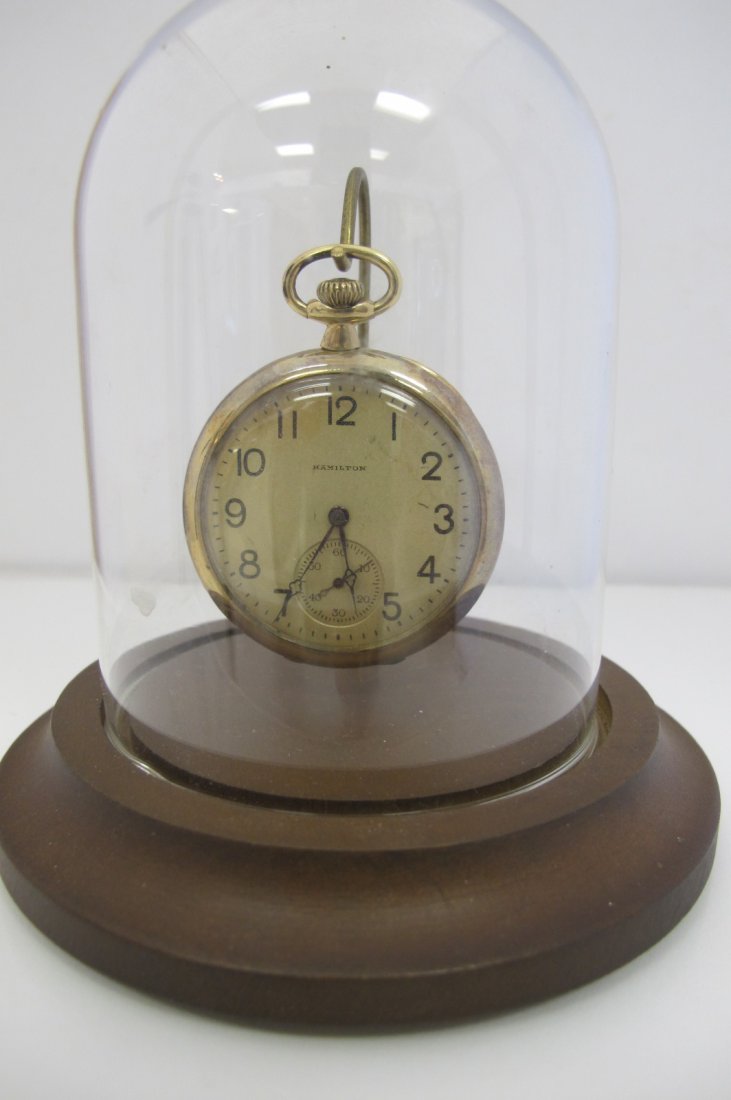 10K Yellow Gold Hamilton Pocket Watch in Glass Dome Dis: 10K Yellow Gold Hamilton Pocket Watch in Glass Dome Display Case. Stamped on inside case: serial # 142518, Stamped Hamilton Watch Co., Lancaster Pa., Stamped on the works: #1897312, 17 Jewels adjusted