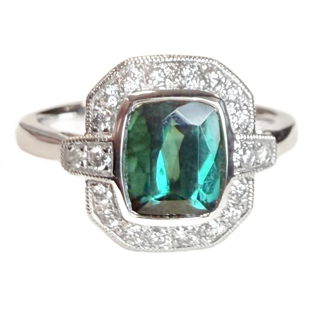 Platinum Natural Indicolite Tourmaline & Diamond Ring: Platinum Natural Indicolite Tourmaline & Diamond Ring. This ring includes one (1) cushion brilliant natural indicolite tourmaline with a faceted cut, weighing 1.52 cts (7.49 x 6.55mm). This ring also