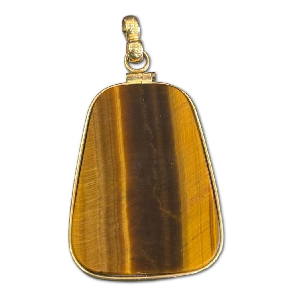 Tiger's Eye Drop Pendant: Tiger's Eye Drop Pendant Measuring Approximately 1.75 x 1.5 inches. Framed with 14k Yellow Gold.