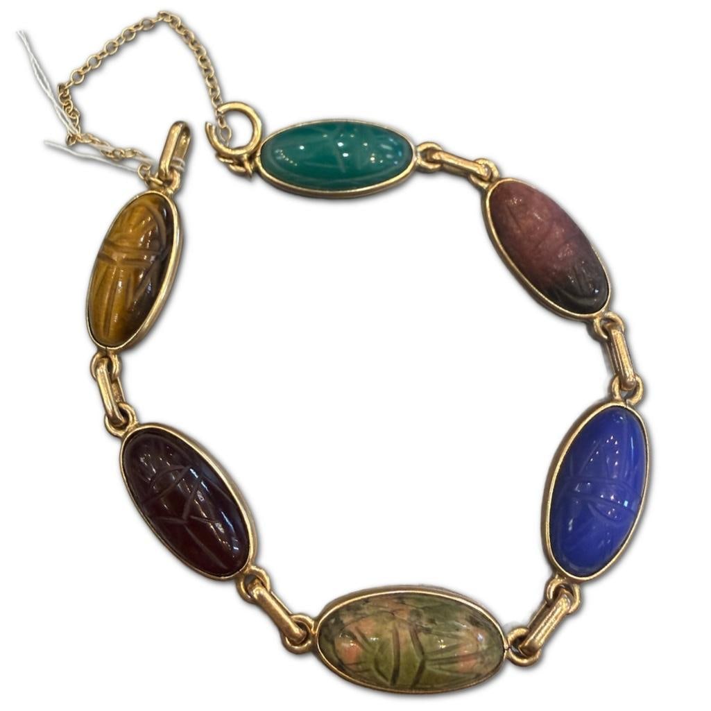 14k Yellow Gold Scarab Bracelet: 14k Yellow Gold Scarab Bracelet Containing Carved Tigers Eye, Garnet, Agate, Lapis Lazuli, and Green Onyx. Clasp is Broken. The Bracelet Measures Approximately 7 inches in Length.