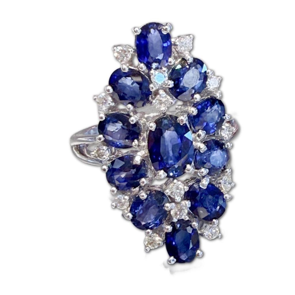 14k White Gold Sapphire & Diamond Cluster Ring: 14k White Gold Sapphire & Diamond Cluster Ring Containing Eleven (11) Oval Cut Sapphires Weighing 5.50cts in Carat Weight. The Sapphires are Deep Vivid Blue in Color. The Ring Also Contains Fourteen