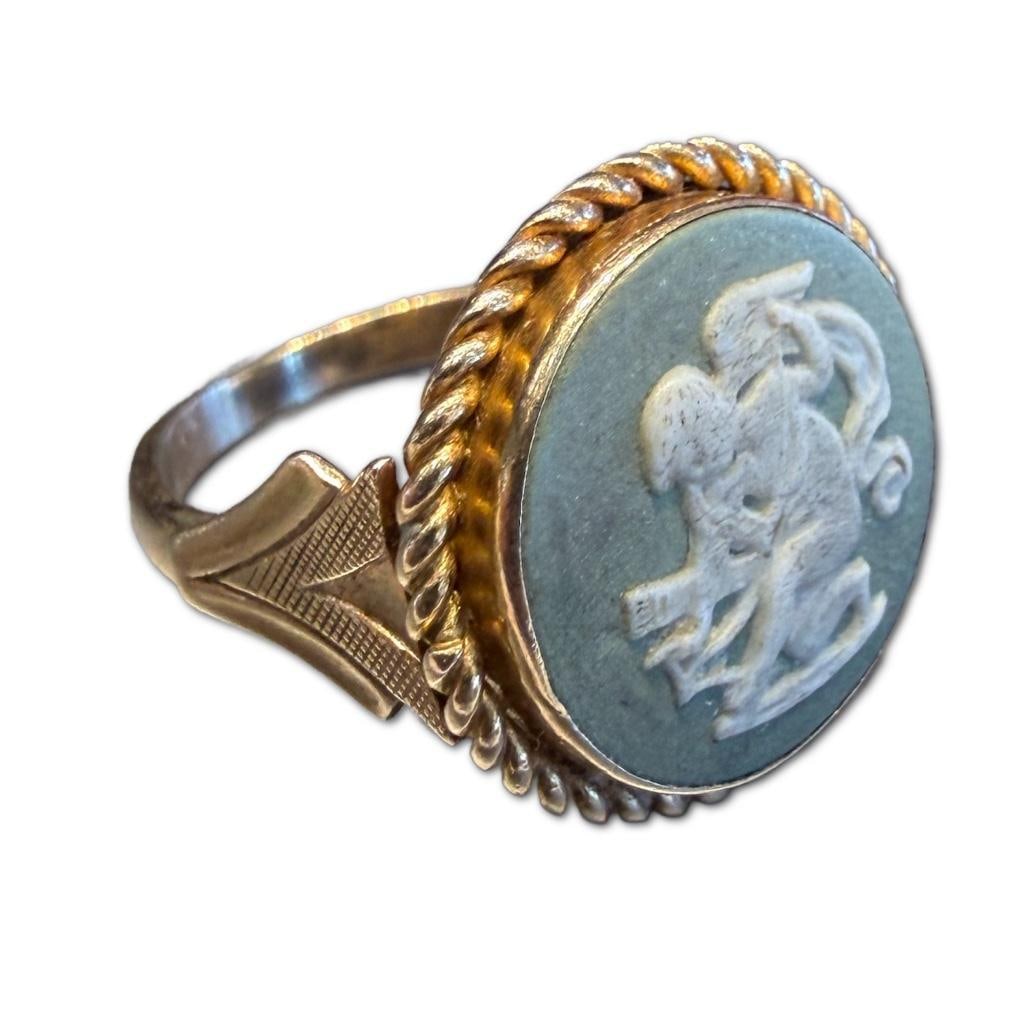 14k Yellow Gold Wedgwood Jasperware Ring: 14k Yellow Gold Wedgwood Jasperware Ring Containing a Putti Motif Carved Raised Jasperware Piece Measuring Approximately 15mm in Diameter. The Ring is sized to a 4.25 and Weighs 2.56dwt